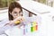 Young female scientist student mixing substances in test tube.