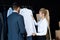 young female seller showing shirts to businessman