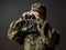 Young female soldier observe with binoculars. War, military, army people concept