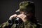 Young female soldier observe with binoculars. War, military, army people concept