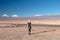 Young female solo traveler walking in hiking trail at Atacama Desert. Single Blond Caucasian girl explore Moon Valley in Chile