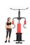 Young female in sportswear standing next to an exercising machine