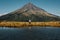 Young female standing near the high Mount Taranaki, Egmont national Park North New Zealand