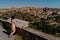 Young female standing on a terrace overlooking a picturesque hillside town in Sepulveda, Spain