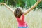 Young female stands in crop field