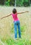 Young female stands in crop field