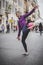 Young female street entertainer performing with her football in the streets of Rome