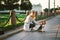 Young female stroking Beagle dog in street