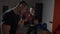 Young female student model taking self defense lessons from a professional male boxer in a gym sport studio in slow motion -