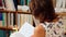 Young female student reading in library