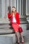 Young female student standing inside office builiding in New York City, looking forward