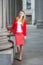 Young female student standing inside office builiding in New York City, looking forward