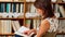 Young female student studying in library