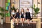 Young female students in school uniforms before the lesson in the classroom.