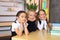 Young female students in school uniforms before the lesson in the classroom.