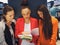 Young female students sharing a book in library