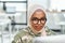 Young female IT support manager in eyeglasses and hijab networking in office