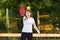 Young female tennis player with tennis ball and racket preparing to serve