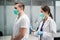 A young female therapist listens to a patient's lungs with a cough after suffering a viral infection