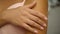 Young female touching her perfect hairless smooth soft and silky shoulder arm skin.