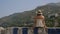 Young female tourist admires the beautiful view of the sea and mountains. Summer in Italy.