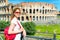 Young female tourist on the background of the Colosseum in Rome