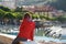 Young female tourist enjoying the view of small yachts and fishing boats in marina of Lerici town, located in the province of La