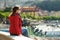 Young female tourist enjoying the view of small yachts and fishing boats in marina of Lerici town, located in the province of La
