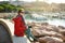 Young female tourist enjoying the view of small yachts and fishing boats in marina of Lerici town, located in the province of La