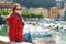 Young female tourist enjoying the view of small yachts and fishing boats in marina of Lerici town, located in the province of La