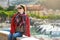 Young female tourist enjoying the view of small yachts and fishing boats in marina of Lerici town, located in the province of La