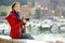 Young female tourist enjoying the view of small yachts and fishing boats in marina of Lerici town, located in the province of La