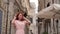 Young female tourist examines streets of old city in Italy, close up