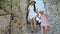 Young female tourist with her daughter is looking with interest at a narrow stone street in a mountain alpine village.