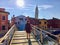 A young female tourist by herself exploring the beautiful view of the famous canals and colourful homes