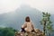 Young female tourist looking on famous Hohenzollern Castle in thick fog, Germany