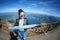 Young female tourist looking map at Rigi mountain in Switzerland with a magnificent panoramic view of Swiss alps