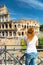 Young female tourist looks at the Colosseum in Rome