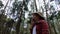 Young female tourist takes off her medical mask while backpacking with enjoying nature in the forest.Women hikers using her mobile