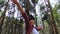 Young female tourist takes off her medical mask while backpacking with enjoying nature in the forest.Women hikers using her mobile