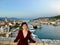 A young female tourist at the top of the Tower Kamerlengo Trogir in the old town of Trogir, Croatia