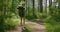 A young female tourist walks through the forest with a backpack and looks at the beauty of nature. Tourism and Hiking