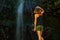 Young female tourist at the waterfall at the Levada do Caldeirao Verde, Queimadas, Madeira