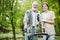 Young female trainee with elder man in the nursing home