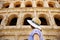 Young female traveler looking on famous the Colosseum in Rome