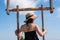 Young female traveler play swing in the highlands of Ban Pha Hee, Mae Sai, Chiang Rai Province, Thailand