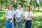 young female volunteers with watering can shovel and rake standing