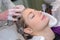 Young female woman having hair washed in beauty salon