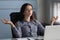 Young female worker making yoga breathing exercises.