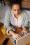 Young female worker typing on laptop